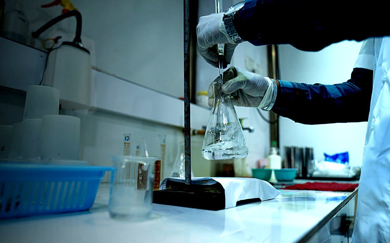 Quest lab technician performing precision chemical testing